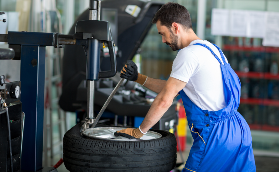 mechanic-replace-tires-on-wheels